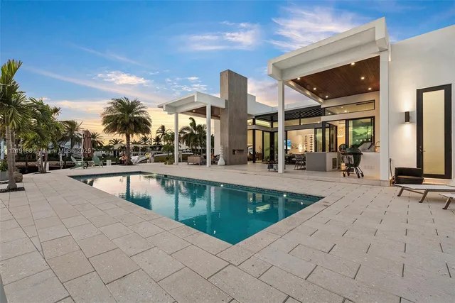 a swimming pool with outdoor seating and yard