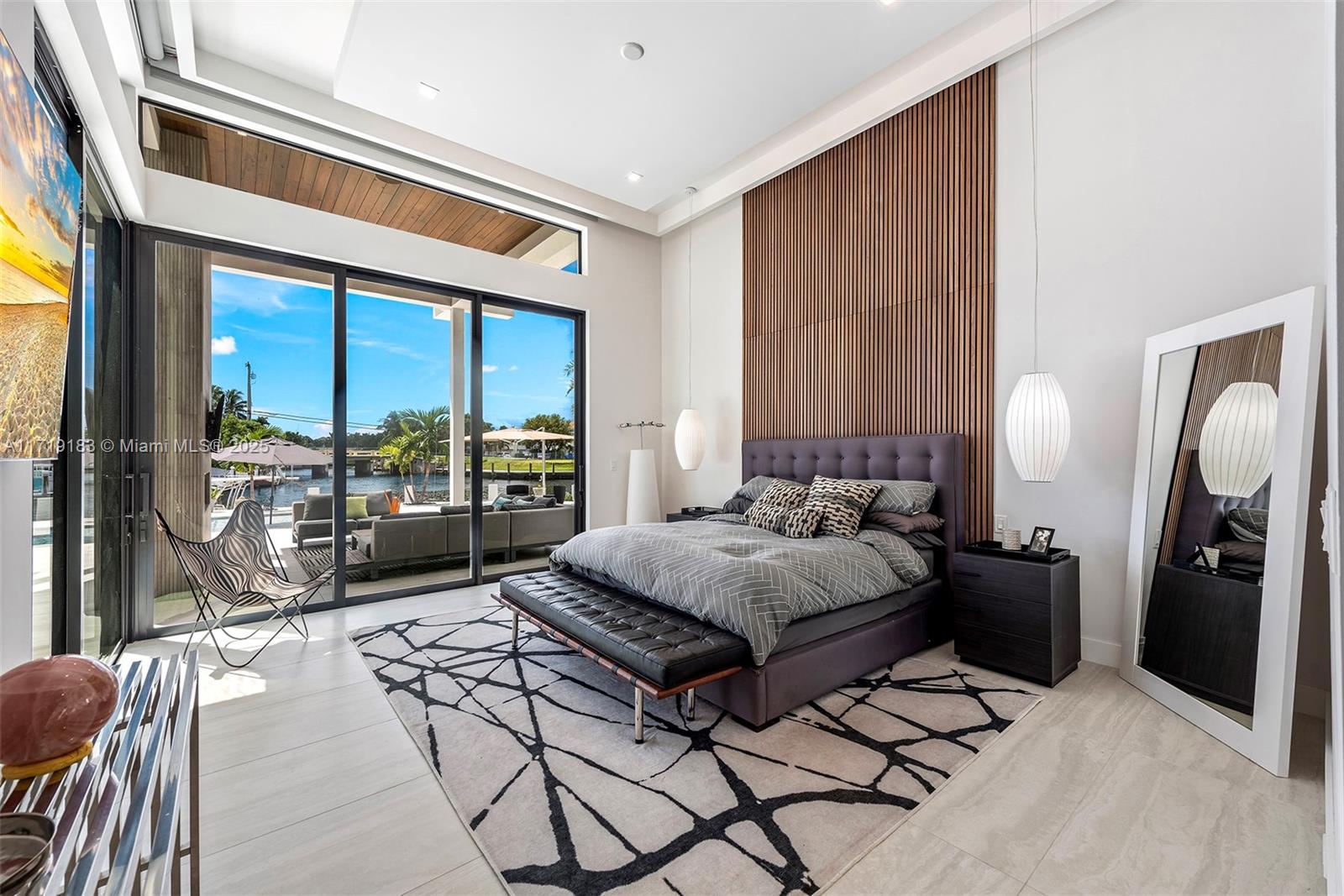 3701 Northeast 26th Avenue Lighthouse Point, FL 33064 - Photo 34 of 65 a bedroom with a bed and a large window