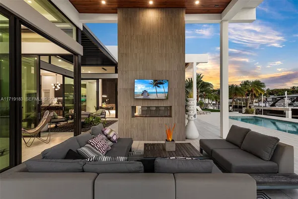 a hallway with a couch and a view of living room