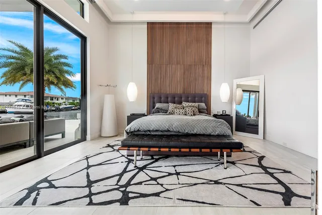 a bedroom with a large bed and a large window with outer view