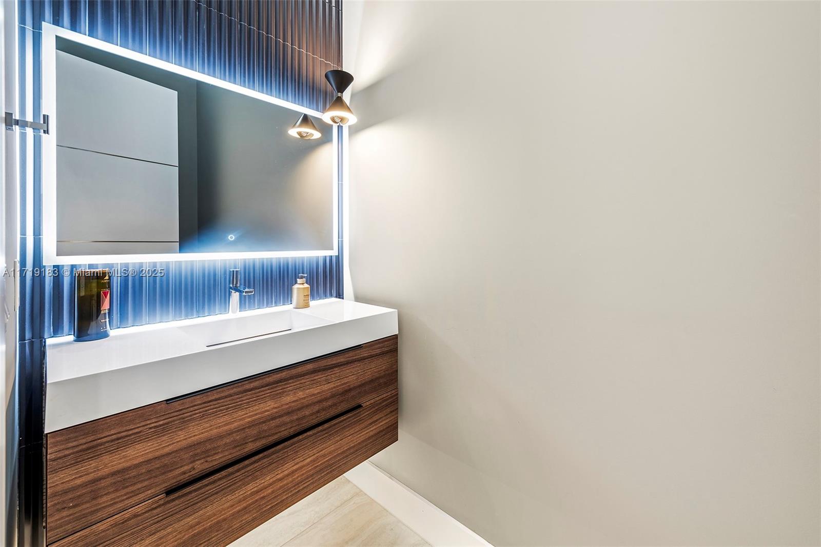 3701 Northeast 26th Avenue Lighthouse Point, FL 33064 - Photo 48 of 65 a bathroom with a sink and a mirror