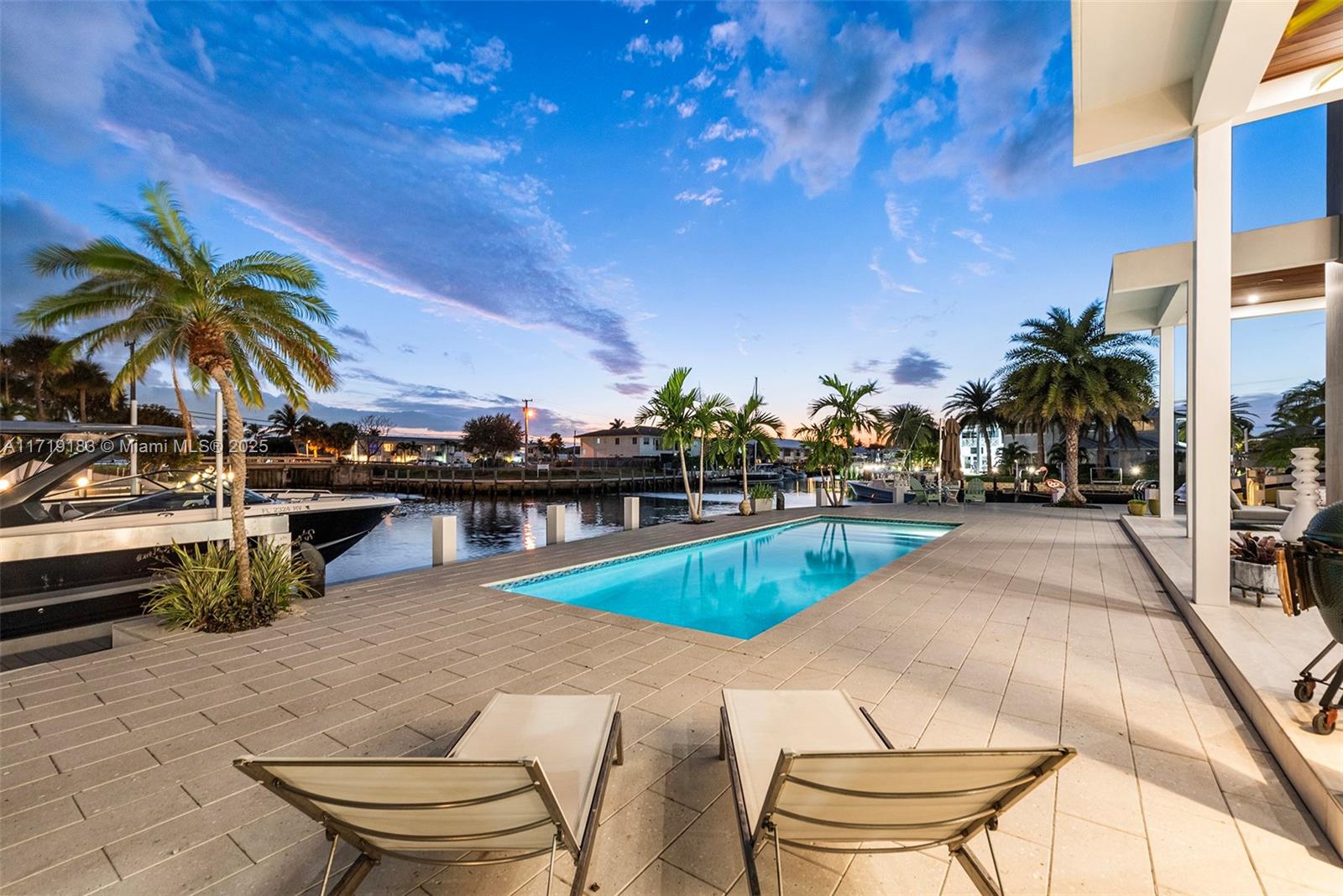 3701 Northeast 26th Avenue Lighthouse Point, FL 33064 - Photo 56 of 65 a view of a swimming pool with an outdoor seating