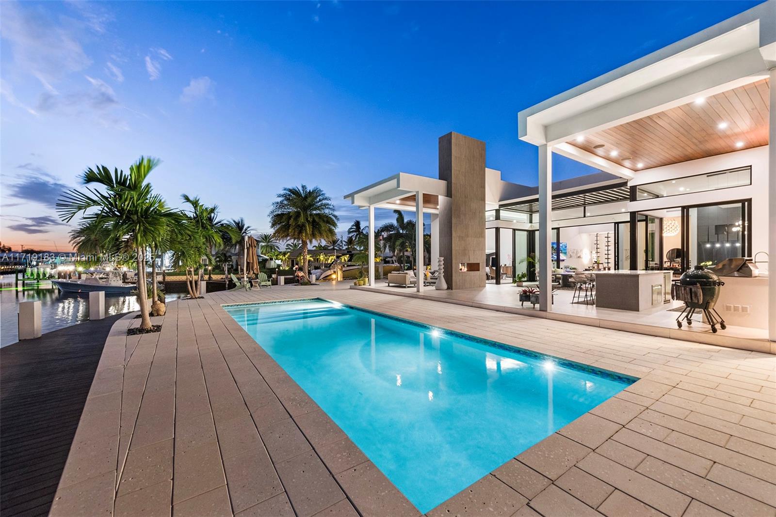 3701 Northeast 26th Avenue Lighthouse Point, FL 33064 - Photo 58 of 65 a swimming pool with outdoor seating and yard