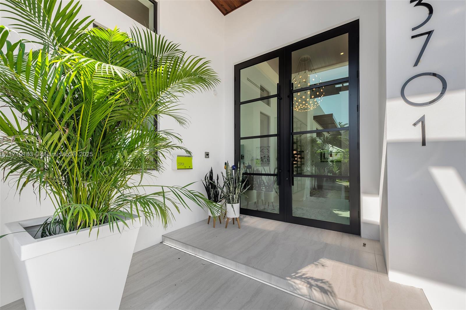 3701 Northeast 26th Avenue Lighthouse Point, FL 33064 - Photo 9 of 65 a view of entryway and hall with wooden floor