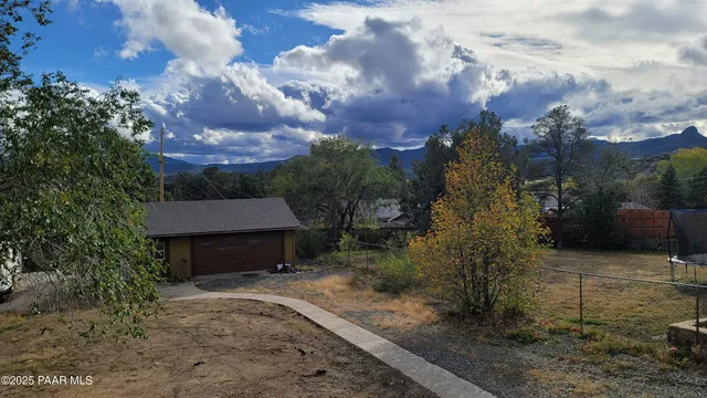 a view of a house with a yard and tree s