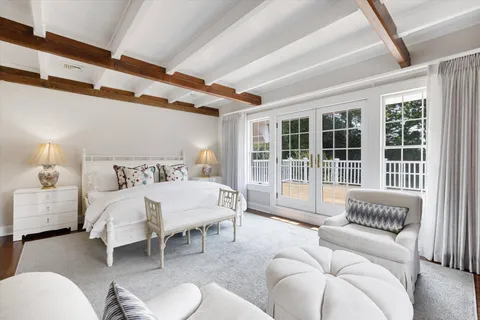 a spacious bedroom with two beds and large windows