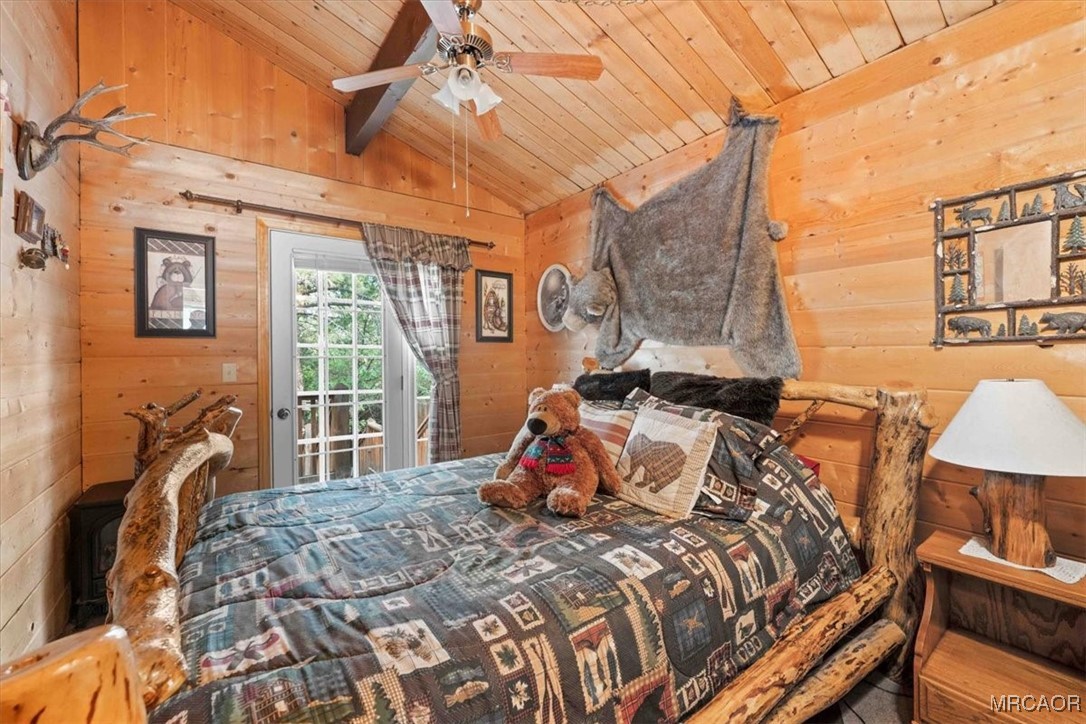 817 Maple Lane Sugarloaf, CA 92386 - Photo 14 of 23 a bedroom with a bed and wooden floor