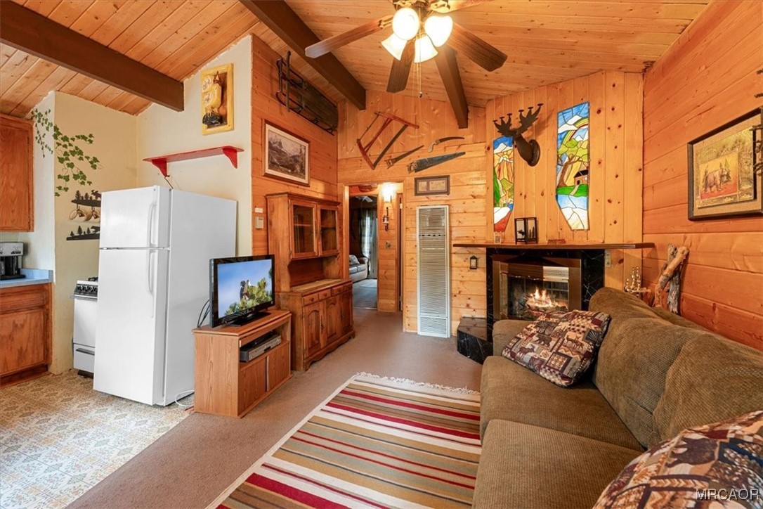 817 Maple Lane Sugarloaf, CA 92386 - Photo 6 of 23 a living room with furniture a fireplace and a chandelier