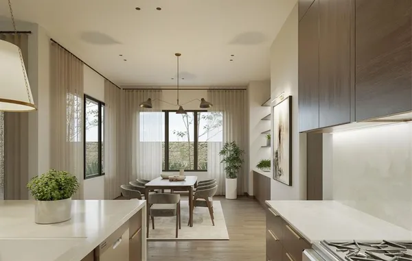 a kitchen with a table and chairs