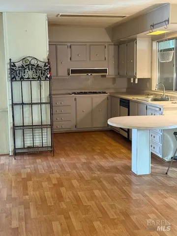 a kitchen with stainless steel appliances granite countertop a sink stove and cabinets
