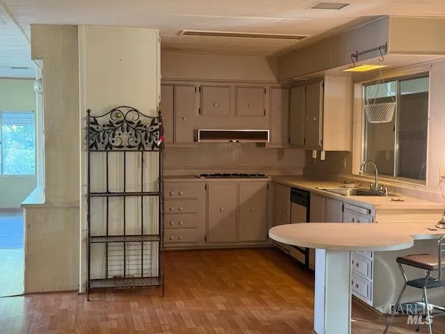 a kitchen with a table chairs sink and cabinets