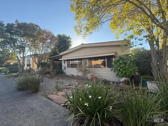 a front view of a house with yard and trees