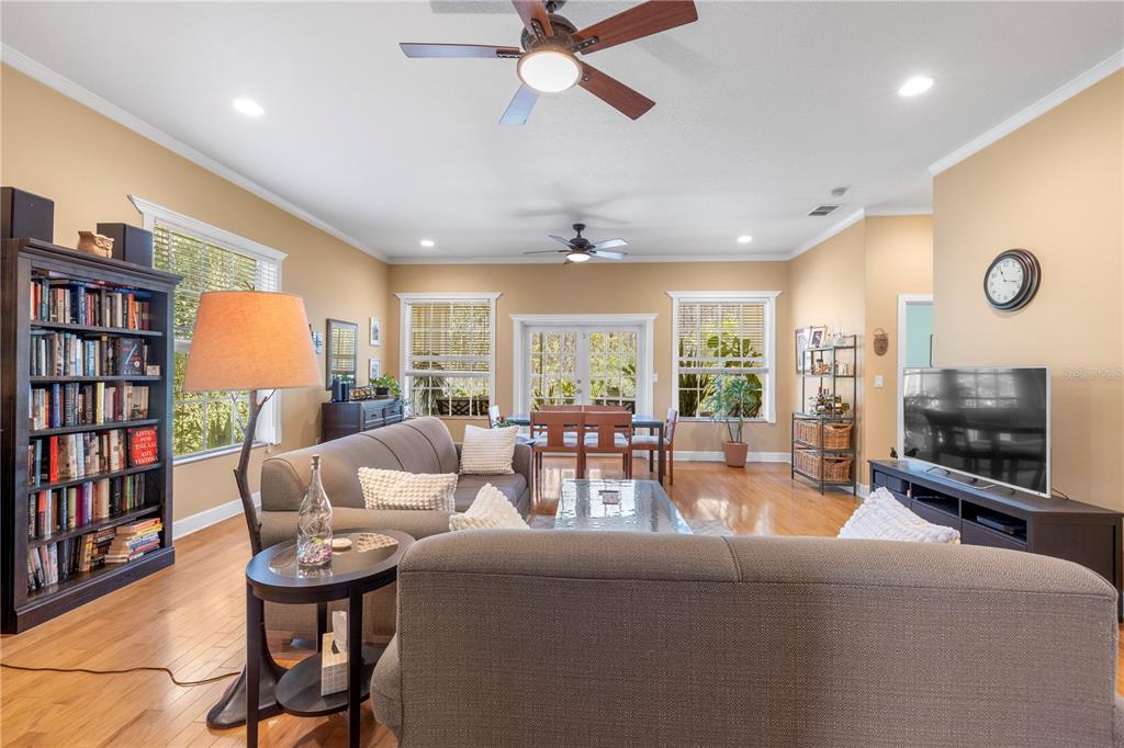 11951 Sheldon Road Tampa, FL 33626 - Photo 11 of 51 a living room with furniture a rug and a flat screen tv
