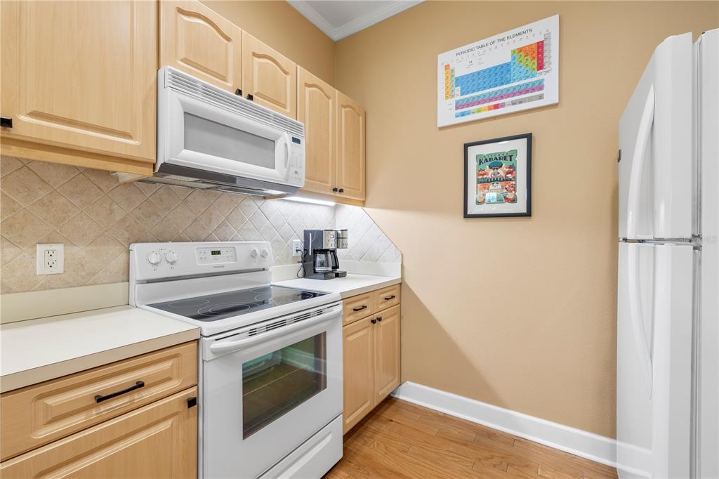 11951 Sheldon Road Tampa, FL 33626 - Photo 18 of 51 a kitchen with stainless steel appliances white cabinets and a stove top oven