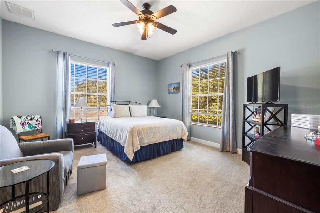 11951 Sheldon Road Tampa, FL 33626 - Photo 22 of 51 a bedroom with a bed and a flat screen television