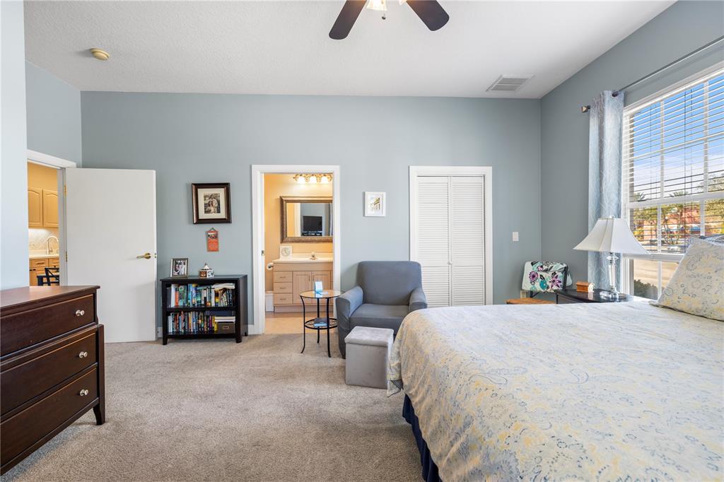 11951 Sheldon Road Tampa, FL 33626 - Photo 23 of 51 a bedroom with a bed furniture and two large window