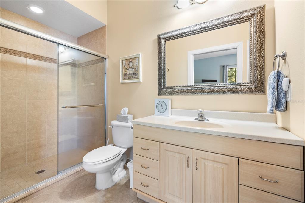 11951 Sheldon Road Tampa, FL 33626 - Photo 25 of 51 a bathroom with a toilet a sink a vanity and mirror