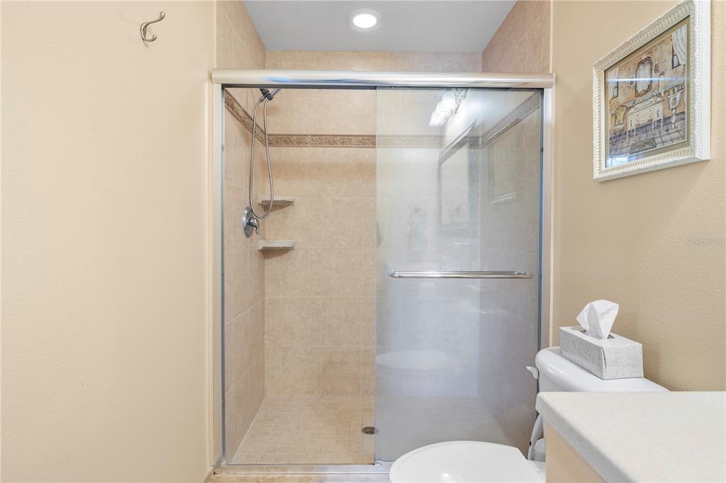 11951 Sheldon Road Tampa, FL 33626 - Photo 27 of 51 a bathroom with a shower a toilet and a sink