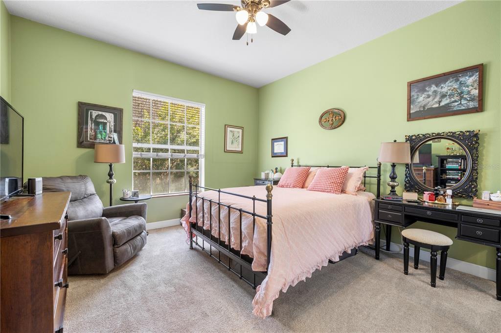 11951 Sheldon Road Tampa, FL 33626 - Photo 28 of 51 a bedroom with a bed couch and a window