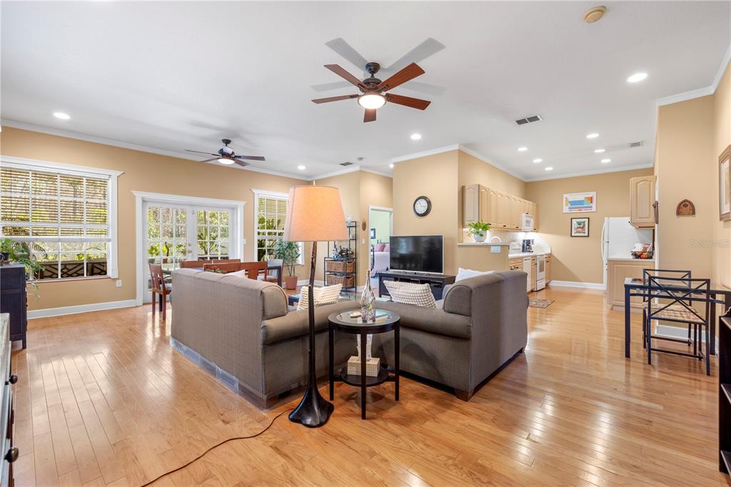 11951 Sheldon Road Tampa, FL 33626 - Photo 10 of 51 a living room with furniture kitchen area and a wooden floor