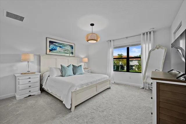 a spacious bedroom with a bed and a window