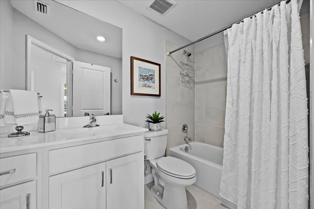 a bathroom with a double vanity sink toilet and shower