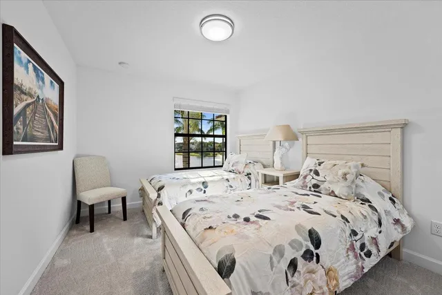 a bed sitting in a bedroom next to a window