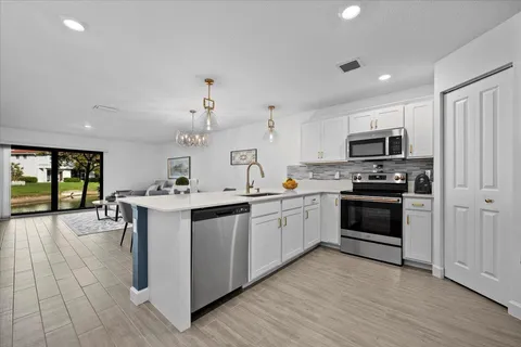 a kitchen with a sink cabinets and stainless steel appliances
