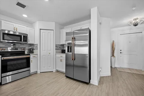 a kitchen with a refrigerator stove and microwave