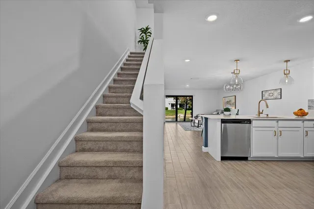 a view of a kitchen with wooden floor and electronic appliances