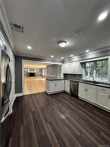 a view of kitchen with wooden floor and large window