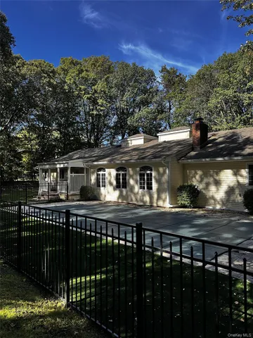 a front view of a house with a wooden fence