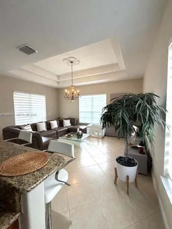 a room with furniture pool table and window