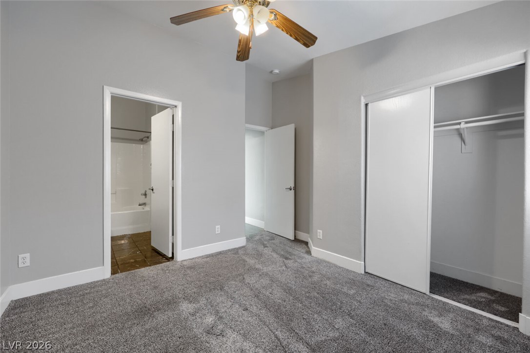 5985 High Steed Street, Unit 101 Henderson, NV 89011 - Photo 23 of 38 A well-lit room featuring plush carpeting and a versatile ceiling fan for comfort.