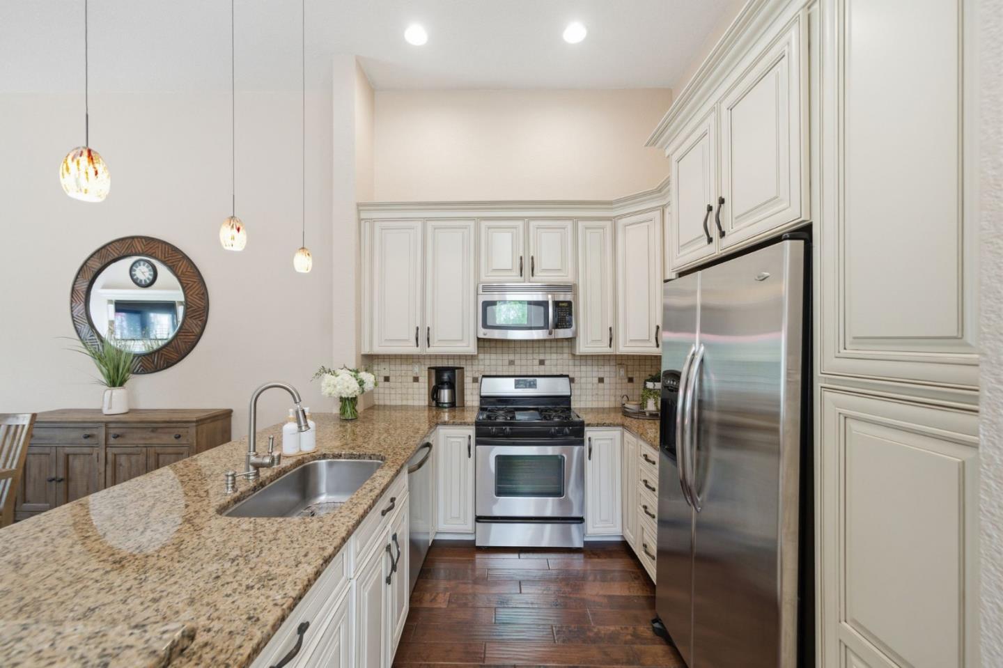 3030 Lakemont Drive, Unit 3 San Ramon, CA 94582 - Photo 17 of 43 a kitchen with stainless steel appliances granite countertop a refrigerator a stove and a sink with wooden floor