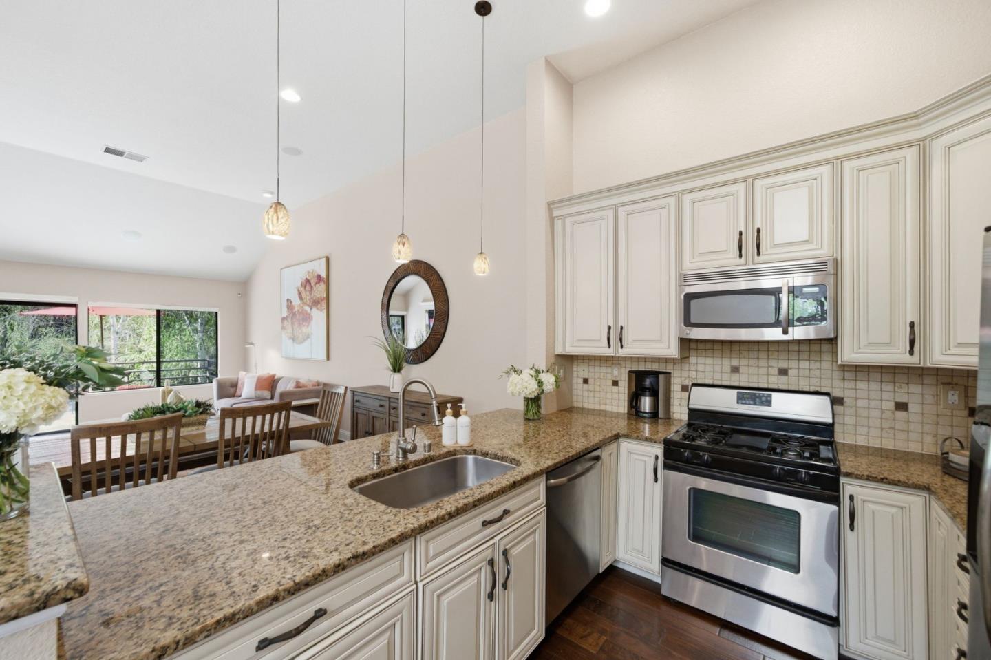 3030 Lakemont Drive, Unit 3 San Ramon, CA 94582 - Photo 19 of 43 a kitchen with stainless steel appliances granite countertop a stove a sink and a microwave