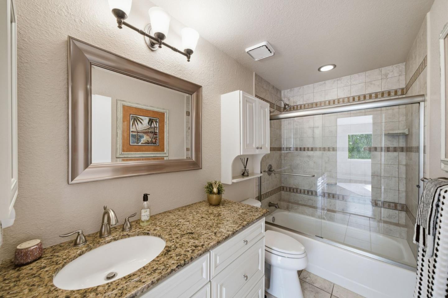 3030 Lakemont Drive, Unit 3 San Ramon, CA 94582 - Photo 21 of 43 a bathroom with a granite countertop sink toilet mirror and shower