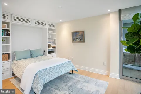 a bedroom with a bed and a potted plant