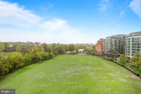 a view of a green field with lake view