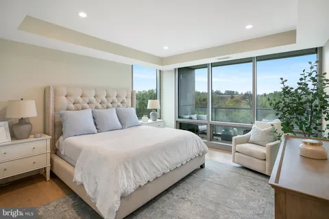 a bedroom with bed and a large window