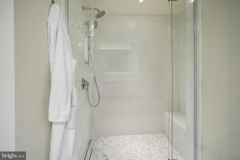 a bathroom with a glass shower door