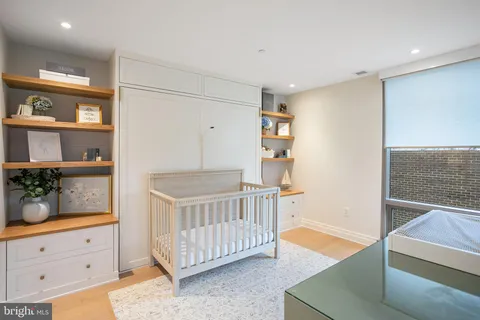 a bedroom with furniture and baby crib