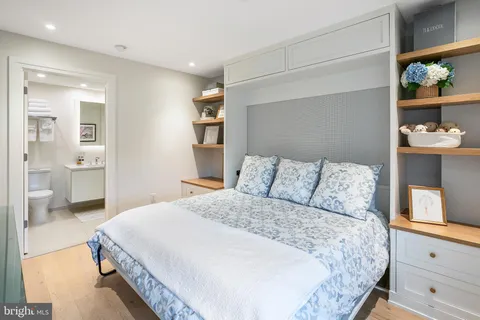 a spacious bedroom with a bed and a cabinets