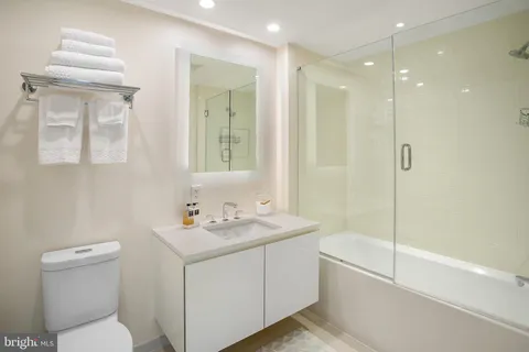 a bathroom with a sink toilet vanity and shower