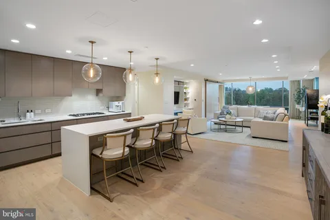 a large kitchen with a table and chairs