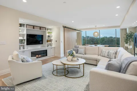a living room with fireplace furniture and a flat screen tv
