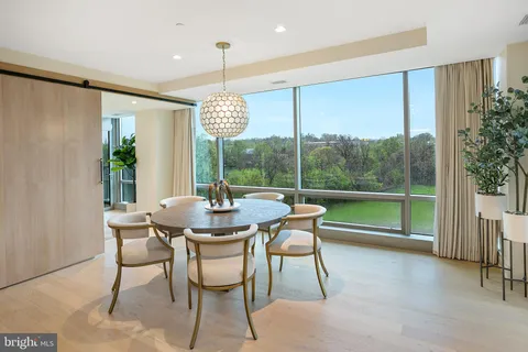 a dining room with furniture a chandelier and pool table