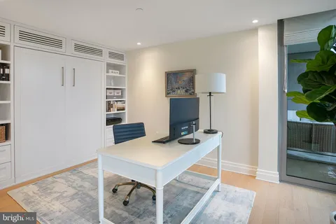 a workspace with furniture and a potted plant