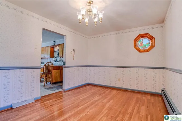 a view of a room with wooden floor and furniture