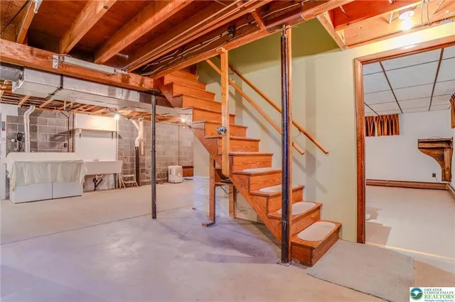 a view of an empty room with storage and a sink